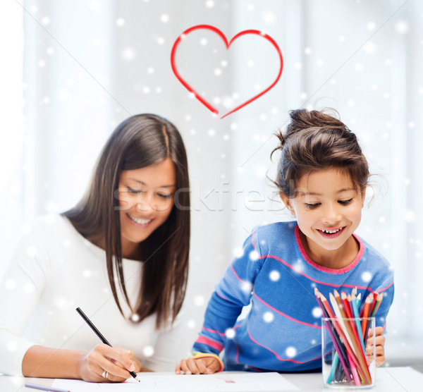 mother and daughter with coloring pencils indoors Stock photo © dolgachov