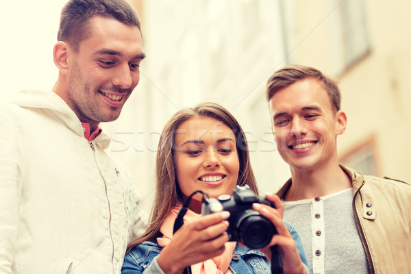 group of smiling friends with digital photocamera Stock photo © dolgachov