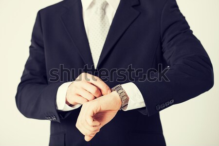 man looking at wristwatch Stock photo © dolgachov