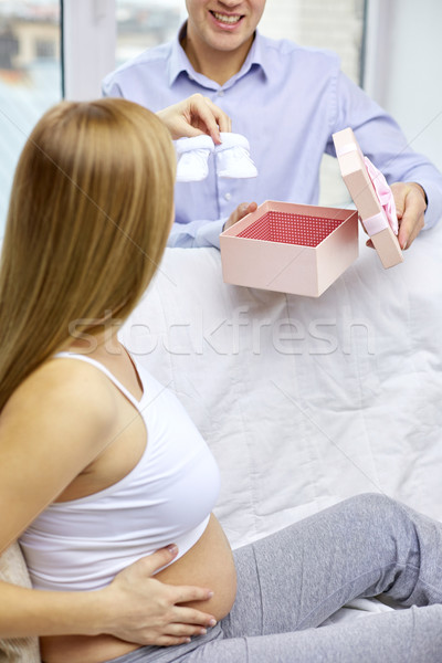 close up of pregnant woman and man with bootees Stock photo © dolgachov