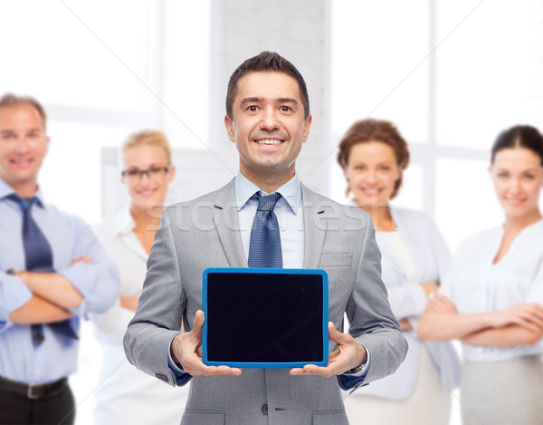 Boldog üzletember öltöny mutat táblagép képernyő Stock fotó © dolgachov