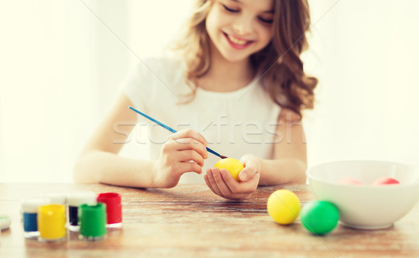 close up of girl coloring eggs for easter Stock photo © dolgachov