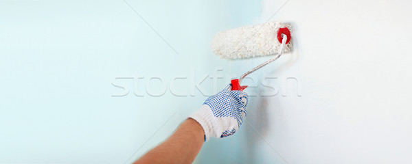 Stock photo: close up of male in gloves painting wall