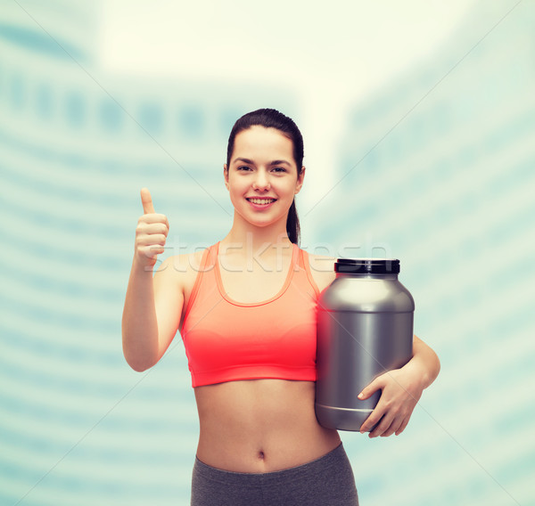 teenage girl with jar of protein showing thumbs up Stock photo © dolgachov