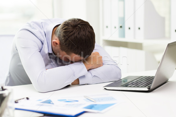 businessman with laptop and papers in office Stock photo © dolgachov