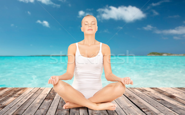 woman meditating in yoga lotus pose Stock photo © dolgachov