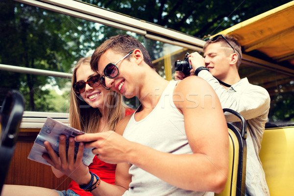 smiling couple with book traveling by tour bus Stock photo © dolgachov