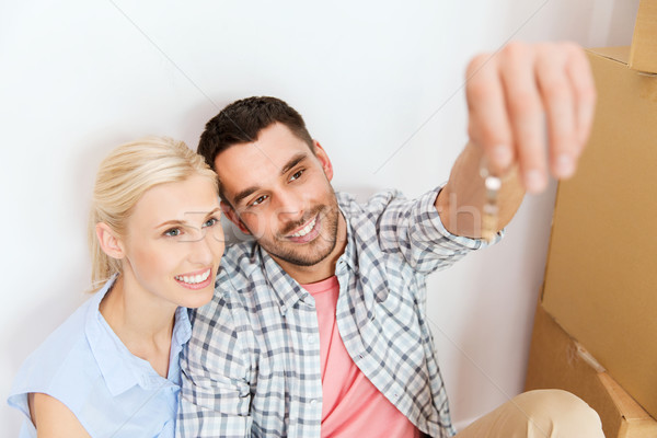 couple with key and boxes moving to new home Stock photo © dolgachov