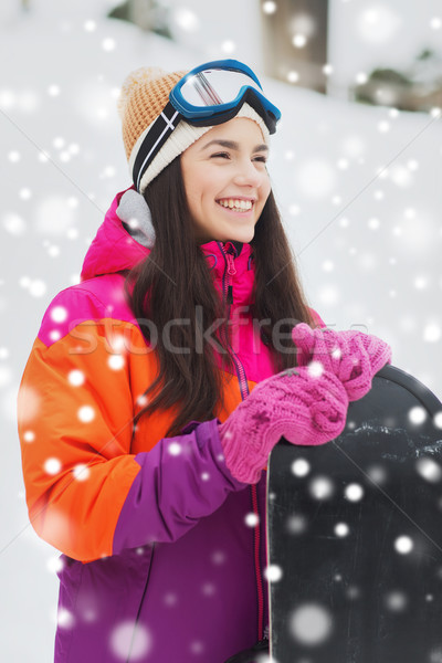 happy young woman with snowboard outdoors Stock photo © dolgachov