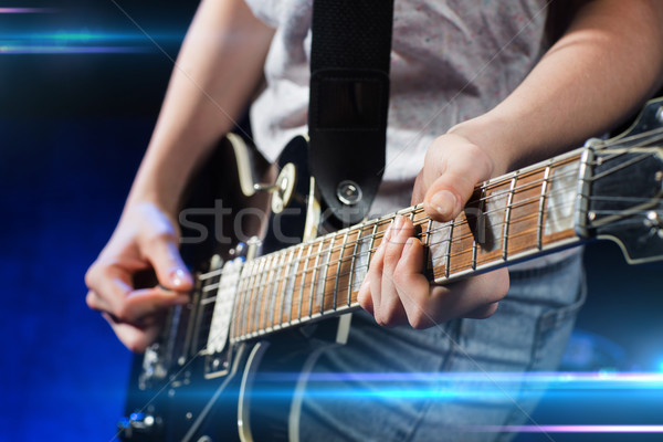 musician playing electric guitar with mediator Stock photo © dolgachov