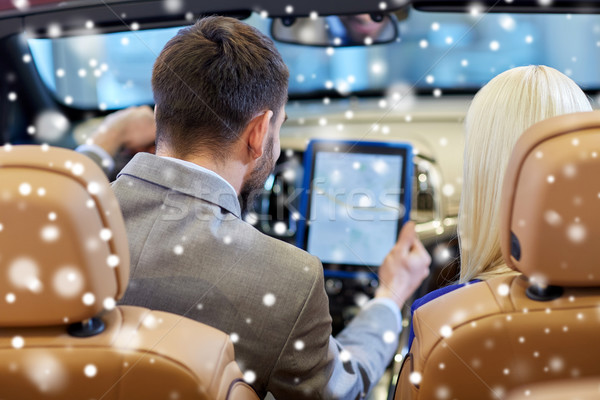 couple sitting in cabrio car with tablet pc Stock photo © dolgachov