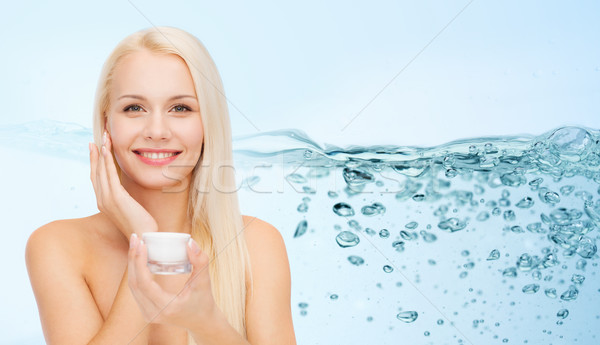 Nő jelentkezik hidratáló krém arc bőr Stock fotó © dolgachov