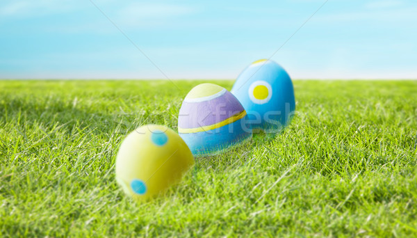 close up of colored easter eggs on grass Stock photo © dolgachov