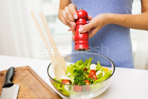 close up of woman cooking vegetable salad at home Stock photo © dolgachov