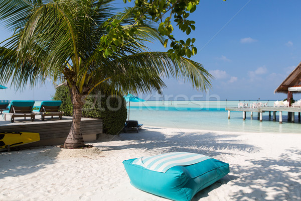 parasol and sunbeds by sea on maldives beach Stock photo © dolgachov