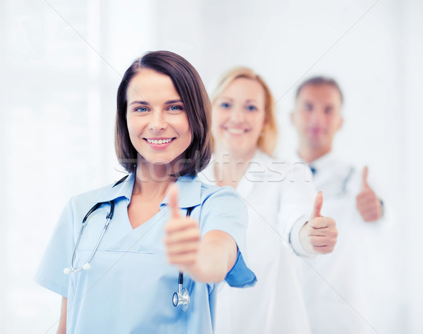 team of doctors showing thumbs up Stock photo © dolgachov