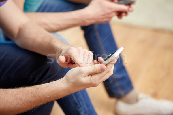 close up of friends with smartphones at home Stock photo © dolgachov