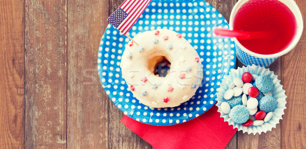 donut with juice and candies on independence day Stock photo © dolgachov