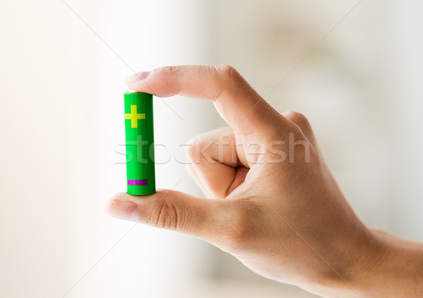 close up of hand holding green alkaline battery Stock photo © dolgachov