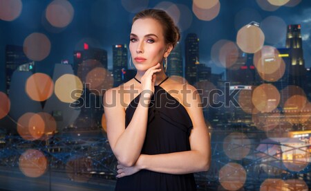 beautiful woman in black hat over night city Stock photo © dolgachov