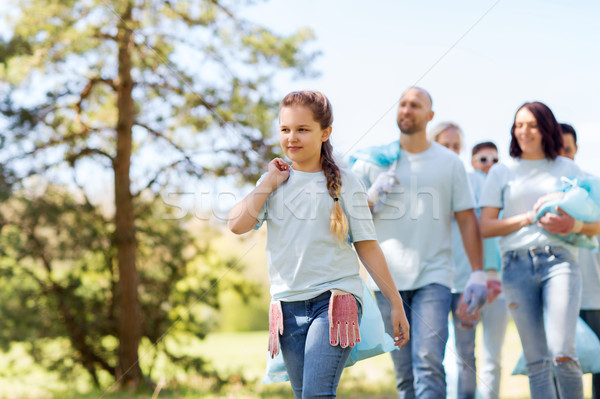 Stock photo: group of volunteers with garbage bags in park
