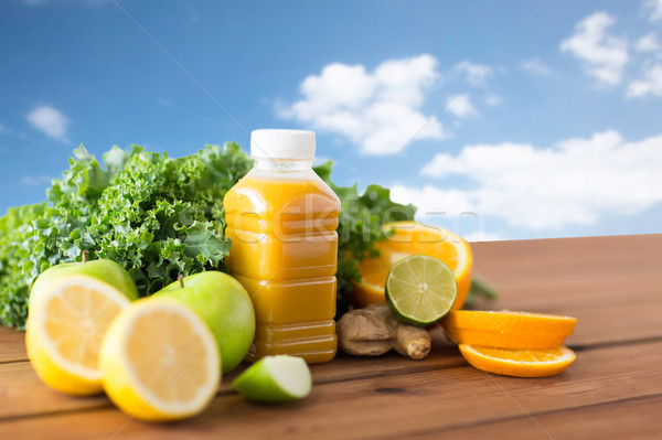 bottle with orange juice, fruits and vegetables Stock photo © dolgachov
