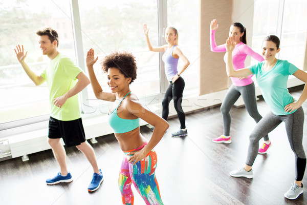 Stock photo: group of smiling people dancing in gym or studio