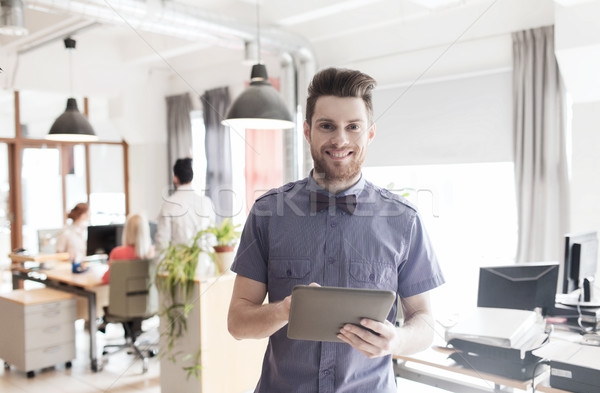 happy creative male office worker with tablet pc Stock photo © dolgachov