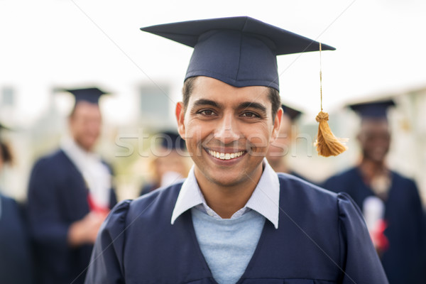 Stock photo: happy student or bachelor in mortar board