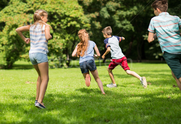 Stock photo: group of happy kids or friends playing outdoors