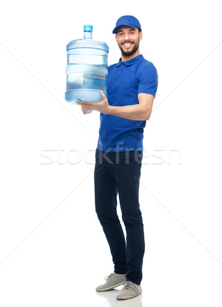 happy delivery man with bottle of water Stock photo © dolgachov