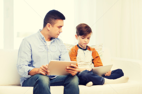 father and son with tablet pc at home Stock photo © dolgachov