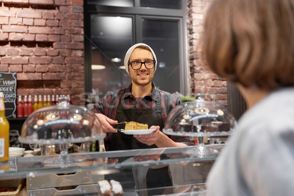 man or barman with cake serving customer at cafe Stock photo © dolgachov