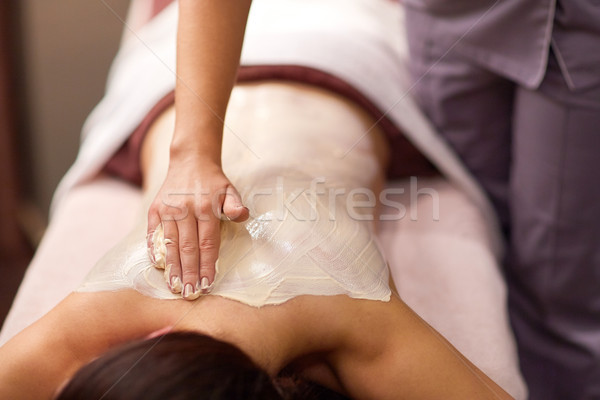 woman having back massage with cream at spa Stock photo © dolgachov