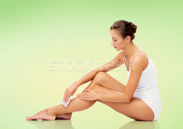 woman with epilator removing hair on legs Stock photo © dolgachov