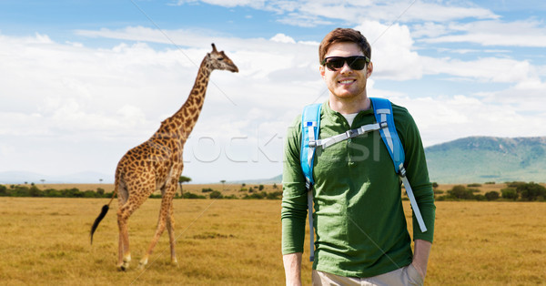 happy young man with backpack traveling in africa Stock photo © dolgachov