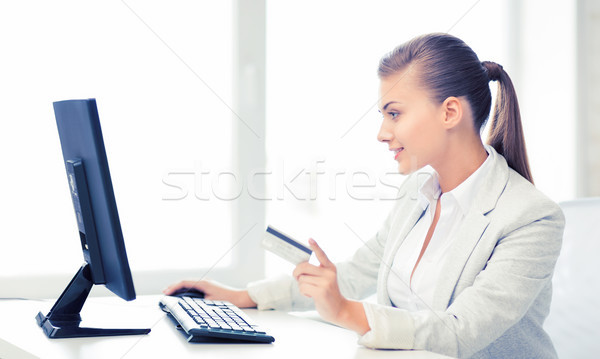 businesswoman with computer using credit card Stock photo © dolgachov