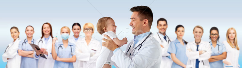 happy doctor or pediatrician with baby over blue Stock photo © dolgachov