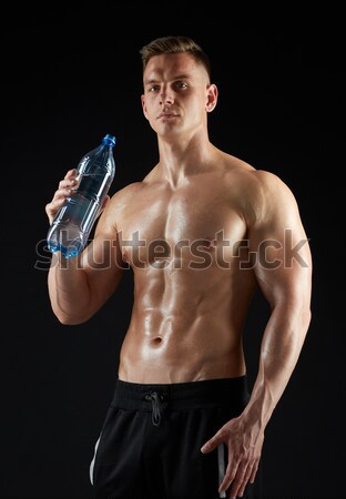 young man or bodybuilder with protein shake bottle Stock photo © dolgachov