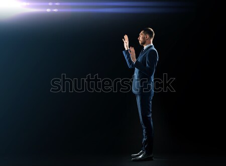 businessman in suit touching something invisible Stock photo © dolgachov