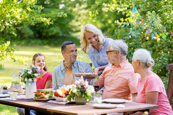Stock photo: happy family having dinner or summer garden party