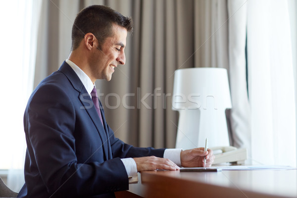 Stock photo: businessman with papers working at hotel room