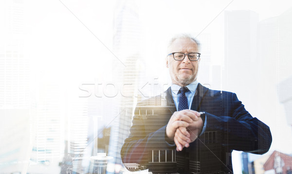 senior businessman checking time on his wristwatch Stock photo © dolgachov