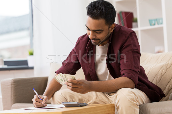 man with money and calculator filling papers Stock photo © dolgachov