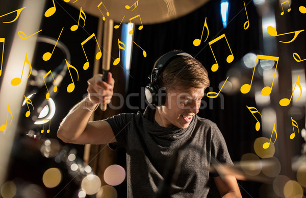 musician in headphones playing drum kit at concert Stock photo © dolgachov