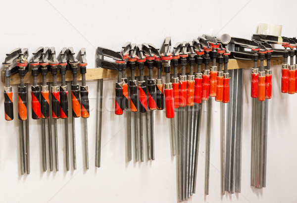 one-handed bar clamps hanging on wall Stock photo © dolgachov