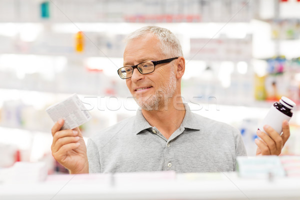 senior male customer choosing drugs at pharmacy Stock photo © dolgachov
