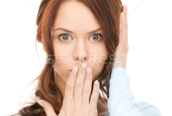woman with hand over mouth Stock photo © dolgachov