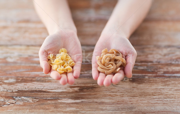 female hands with different pasta variations Stock photo © dolgachov