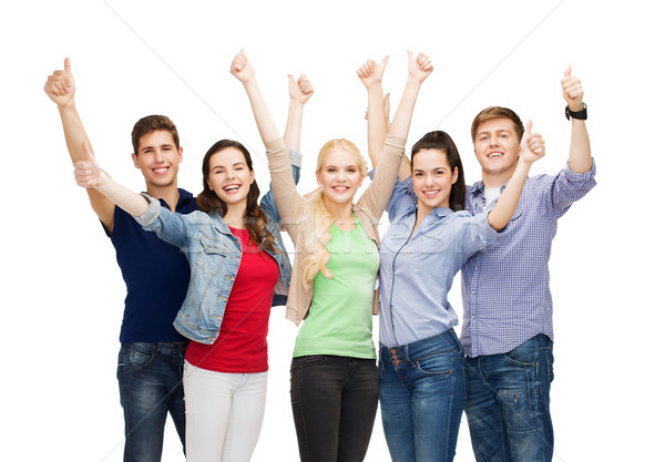 group of smiling students showing thumbs up Stock photo © dolgachov